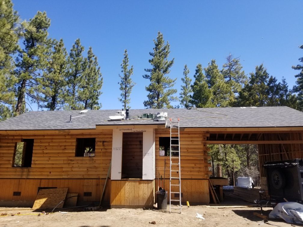 A house under construction with a ladder in front of it