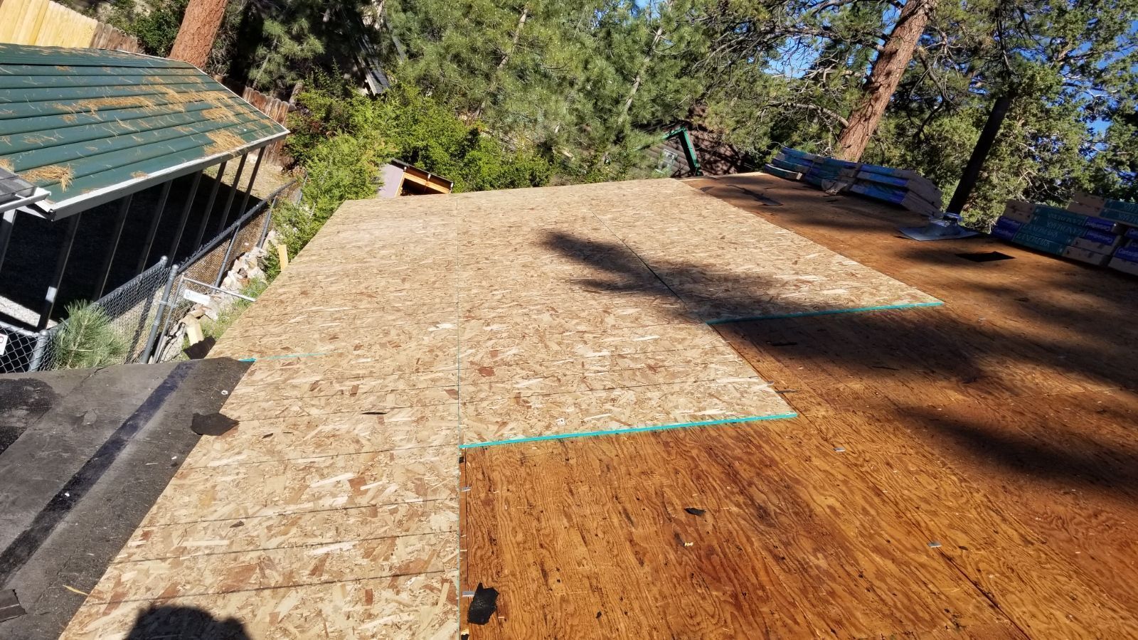 A wooden roof is being built on top of a house.