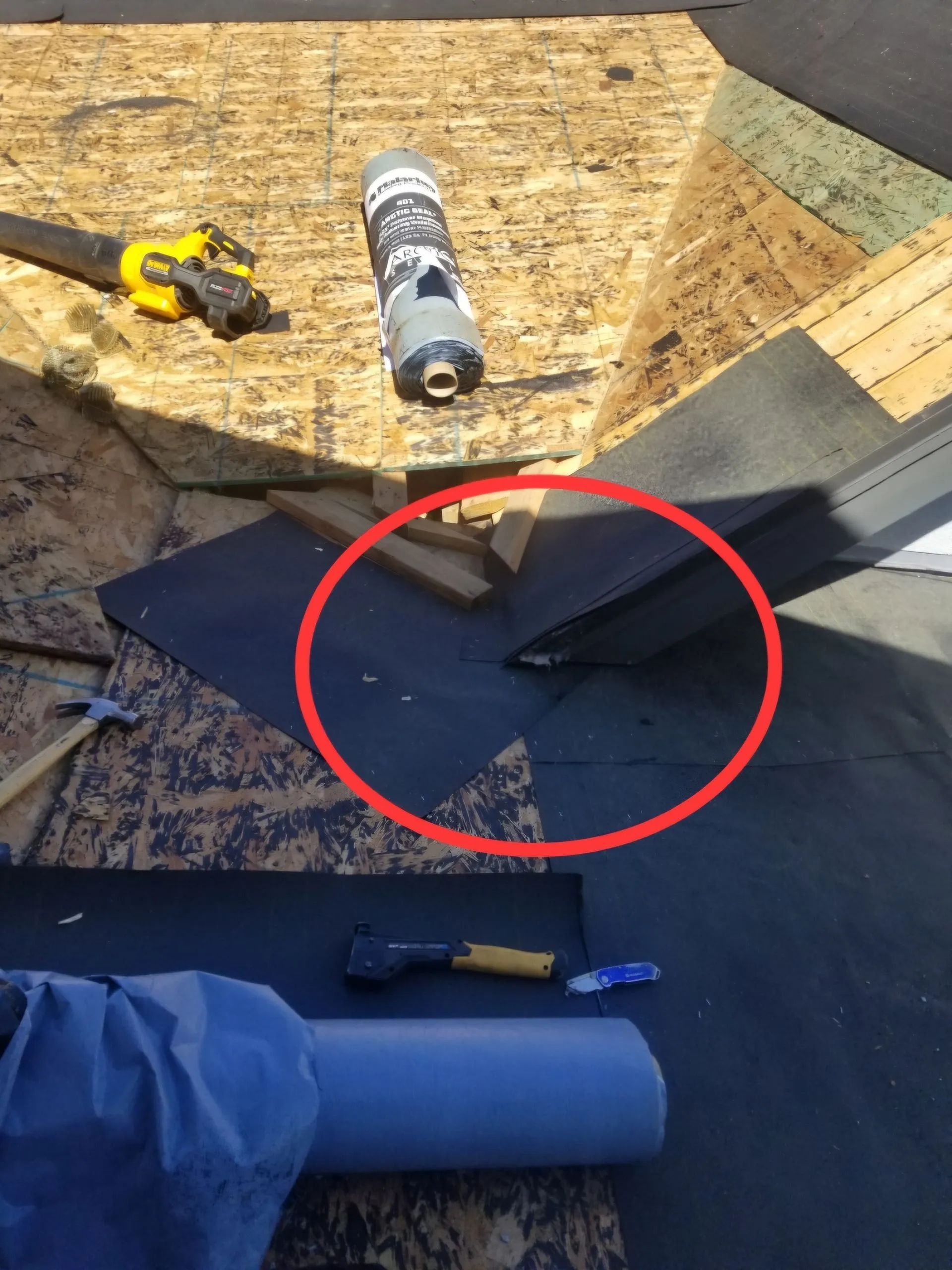 A person is working on a roof with a red circle around it