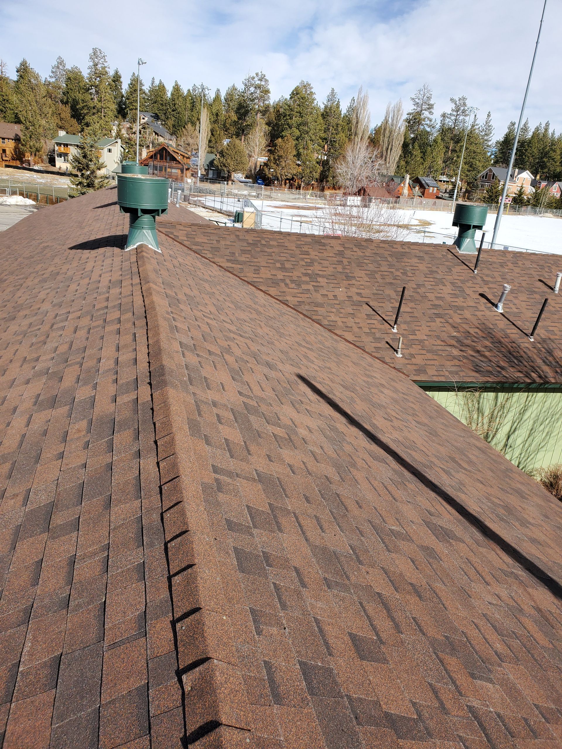A brown roof with a green chimney on top of it.
