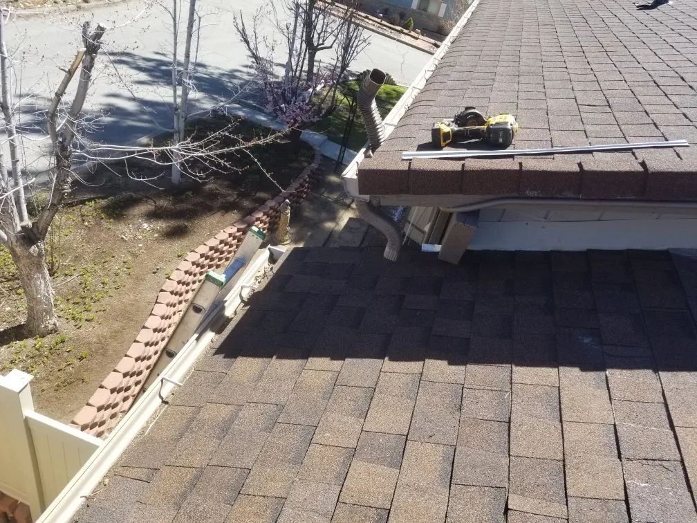 A roof with gutters and a tape measure on it