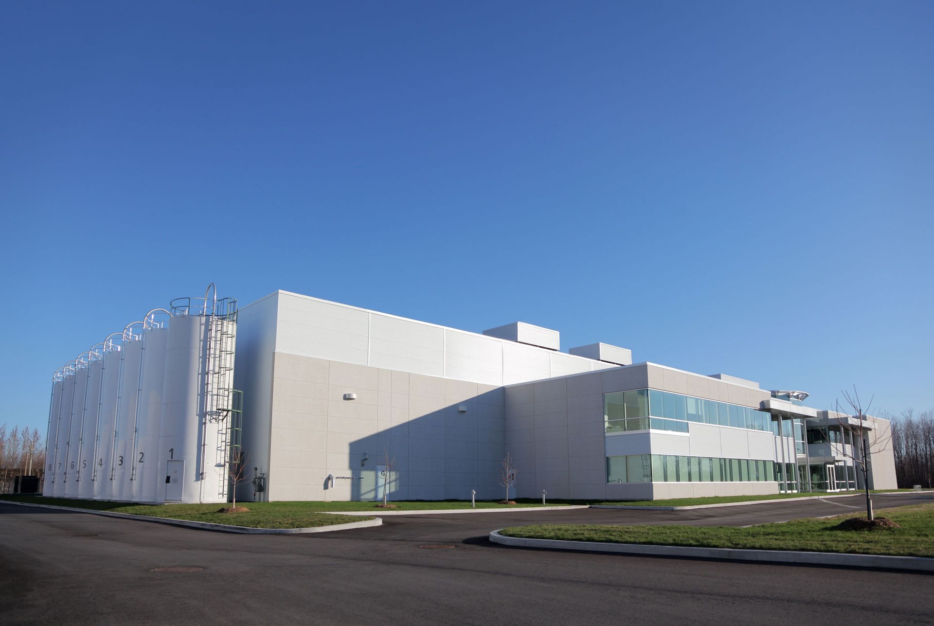 A large white building with a blue sky in the background