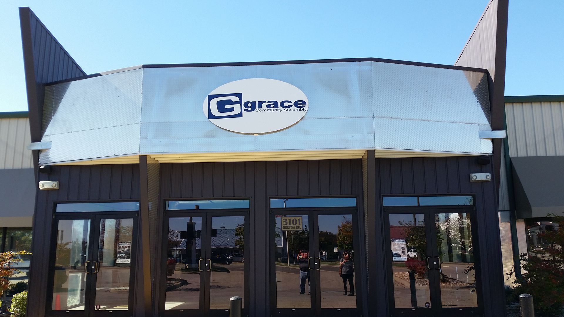 A large blue building with a balcony on the side of it.