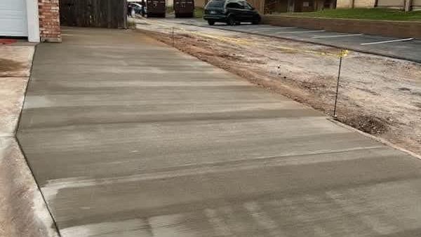 A freshly installed concrete walkway by Key City Concret, designed to improve safety and reduce trip
