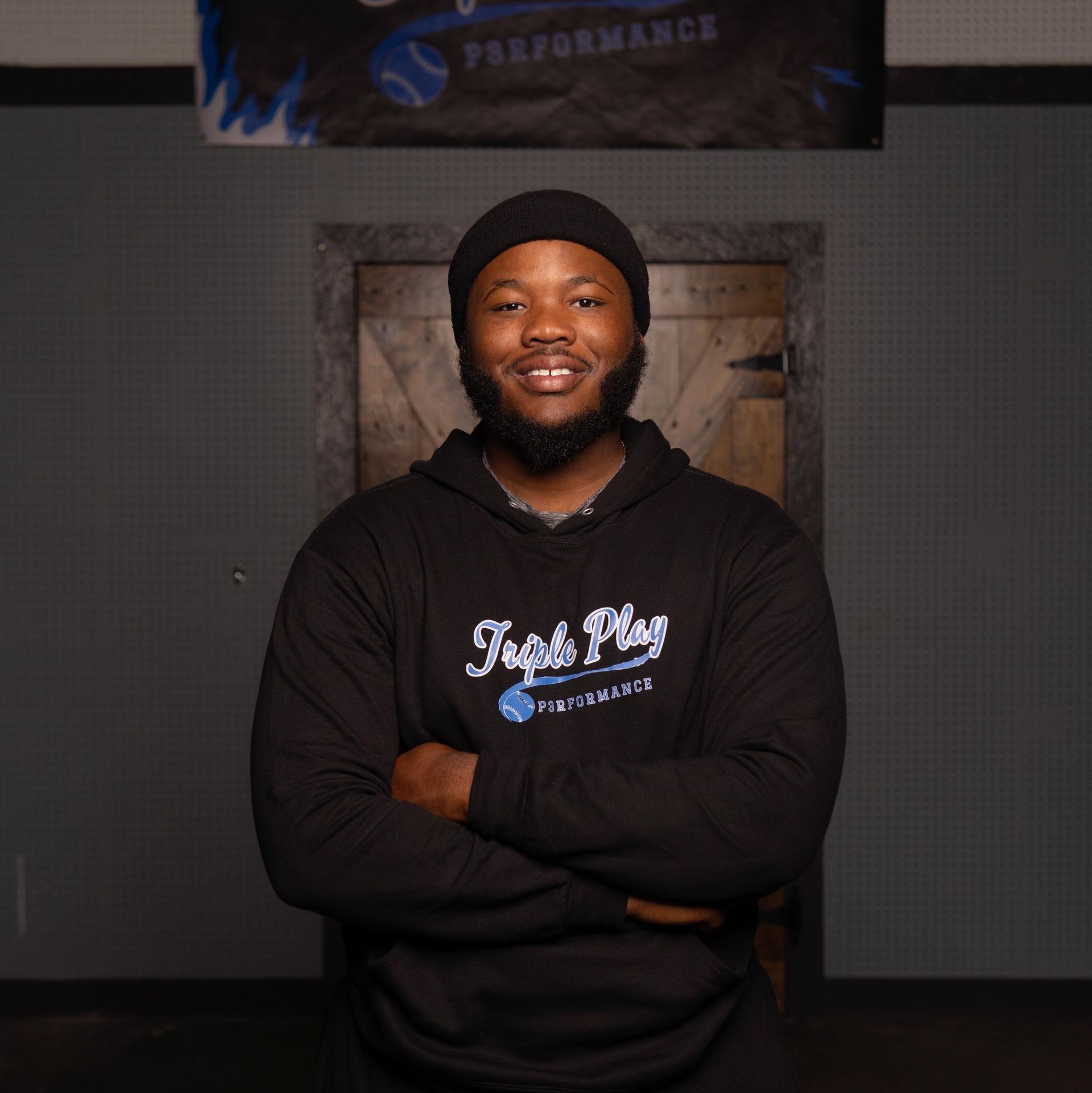 A man wearing a black sweatshirt that says fight play