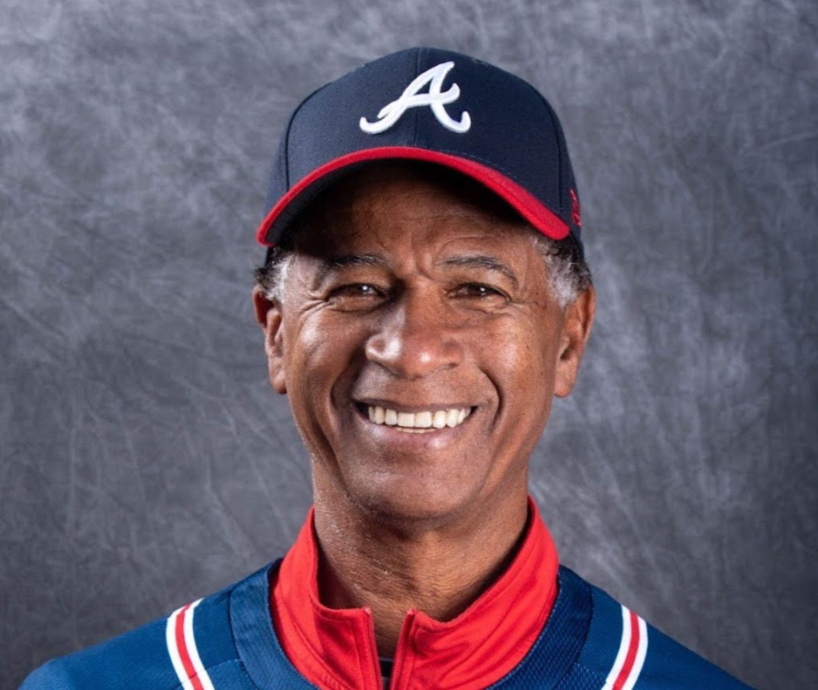 A man wearing a baseball cap with the letter a on it
