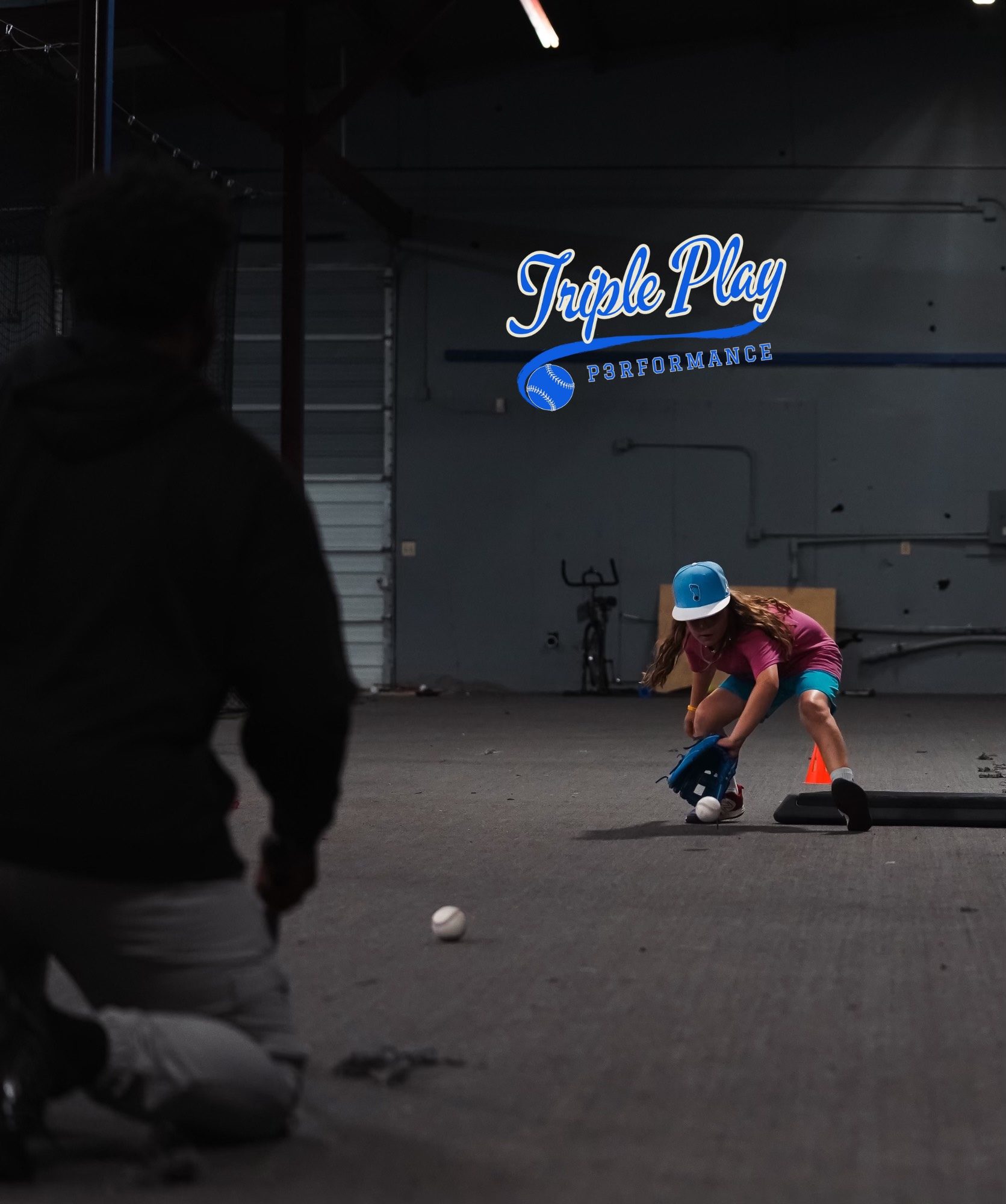 A person is kneeling in front of a sign that says triple play