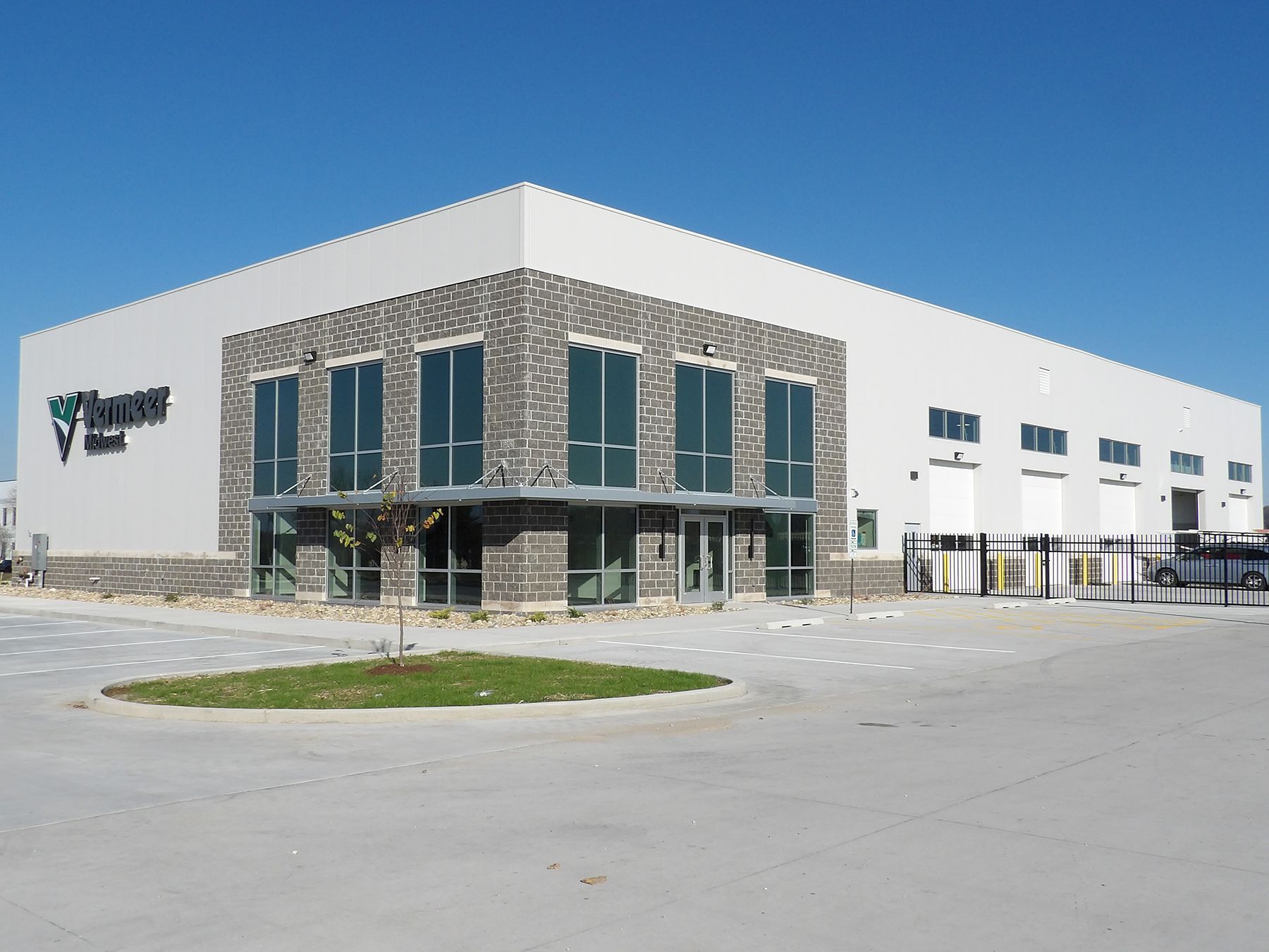 Bar interior with stools, liquor bottles, and a lit sign.