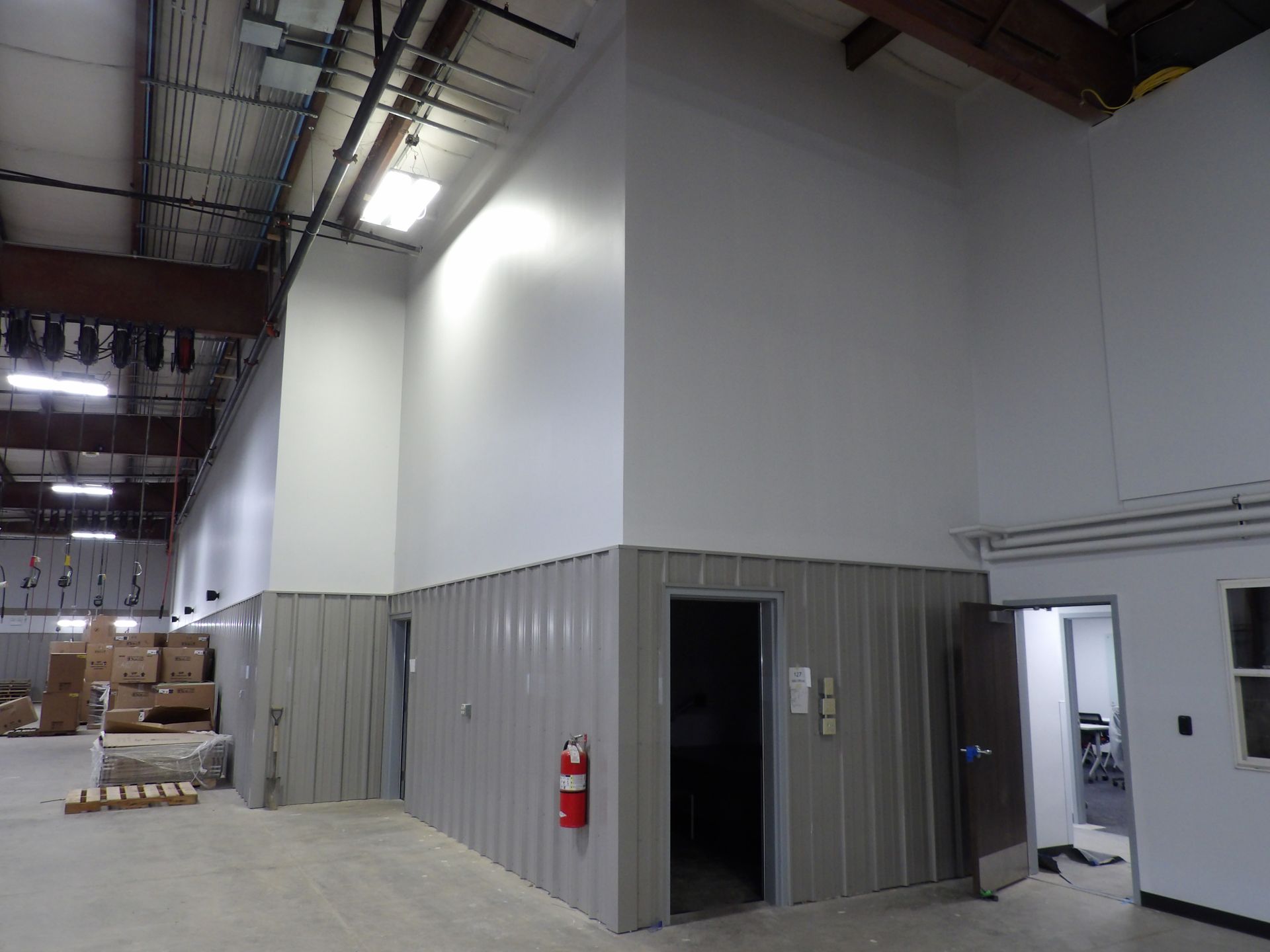 Bar interior with stools, liquor bottles, and a lit sign.