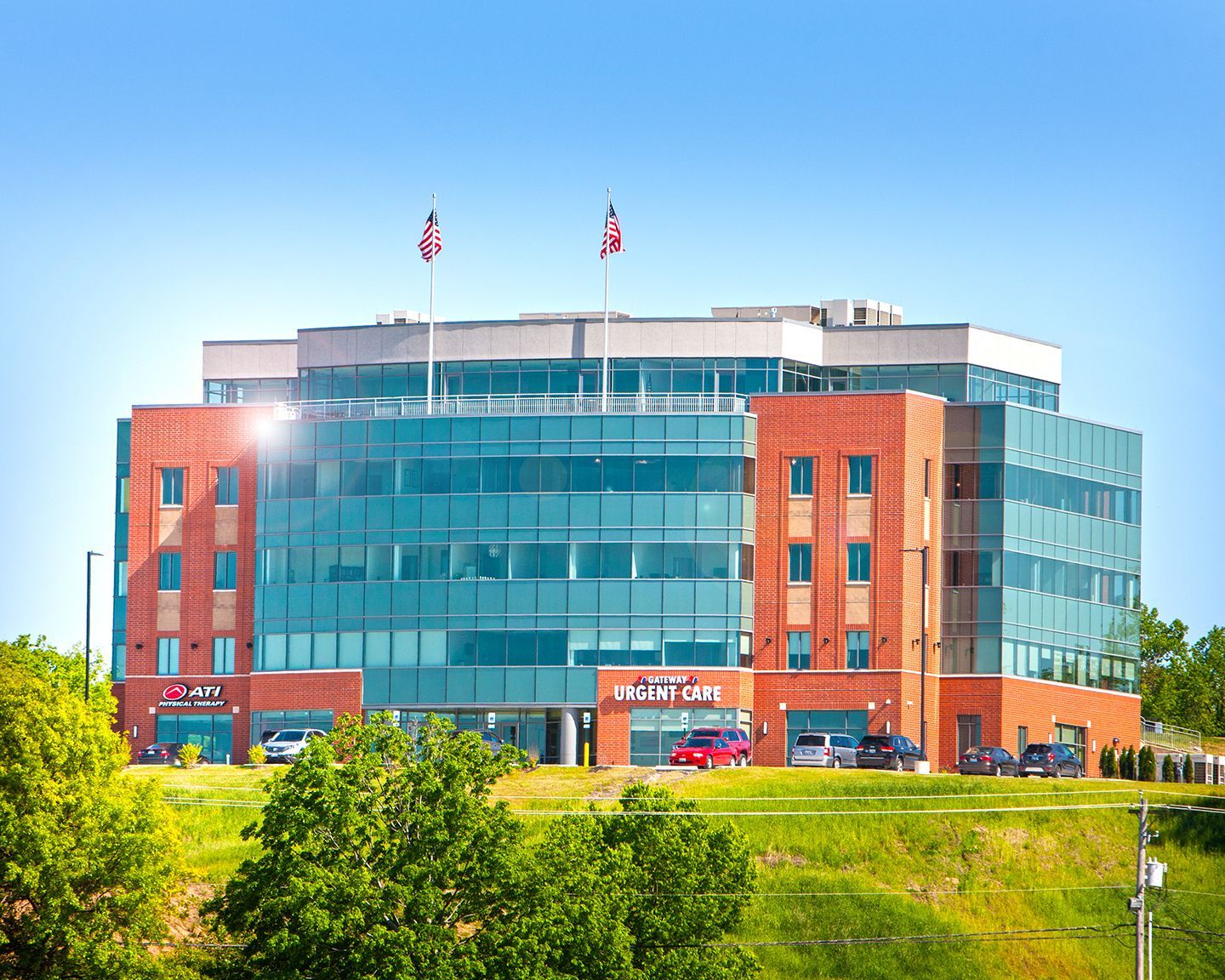 Bar interior with stools, liquor bottles, and a lit sign.