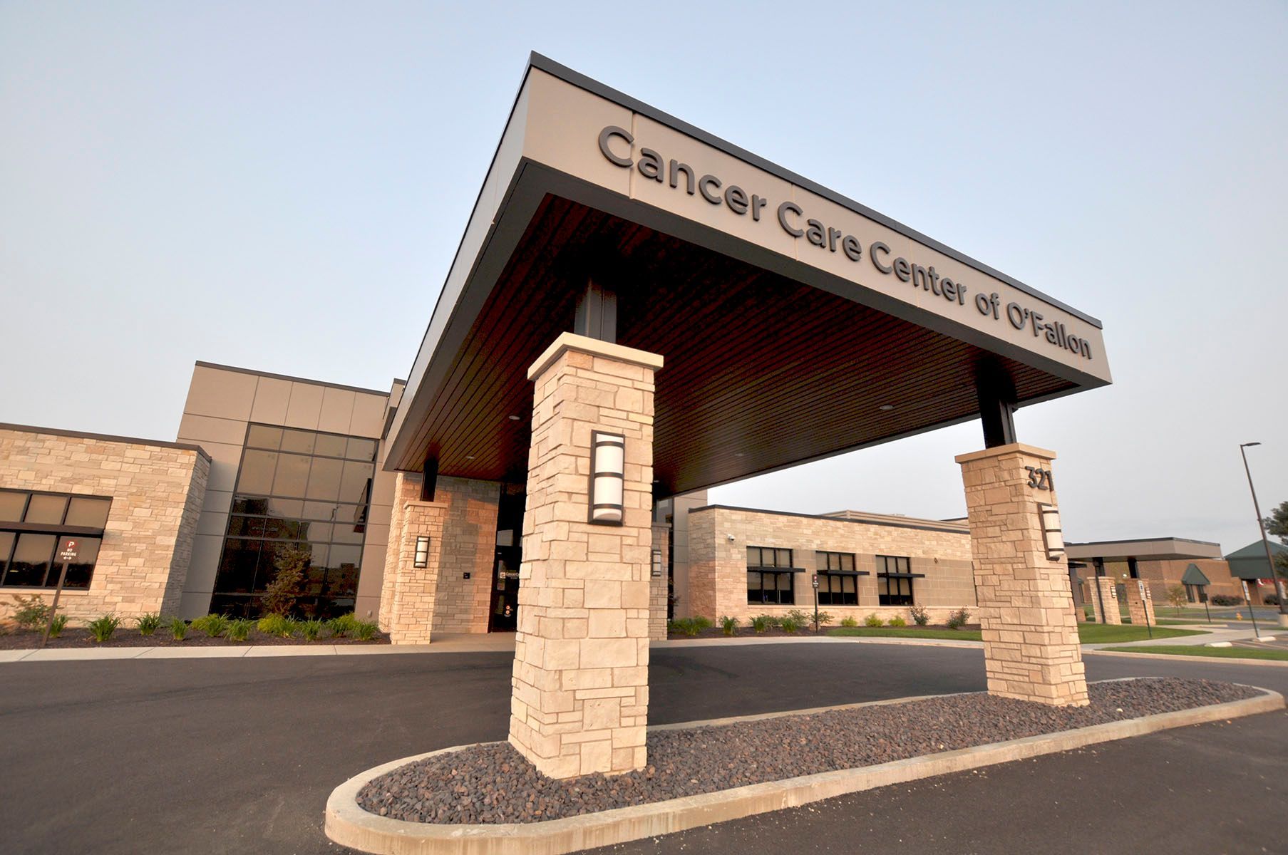 Cancer Care Center of O'Fallon building entrance with stone pillars supporting a dark awning.