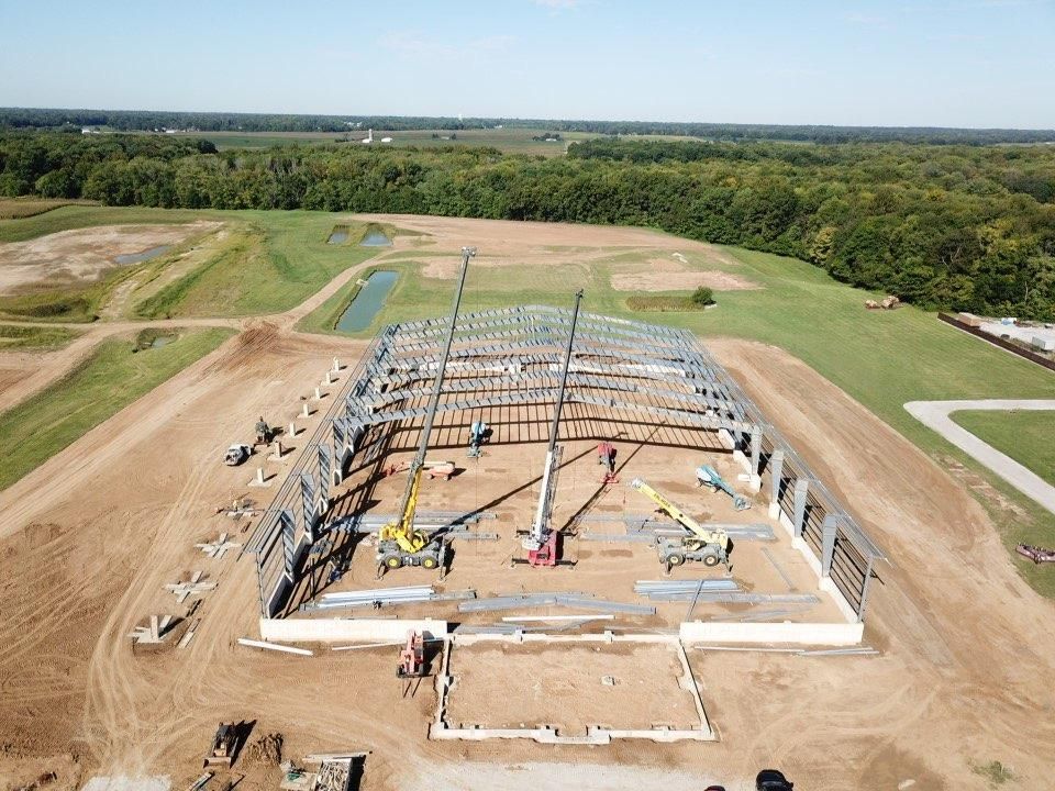 Bar interior with stools, liquor bottles, and a lit sign.