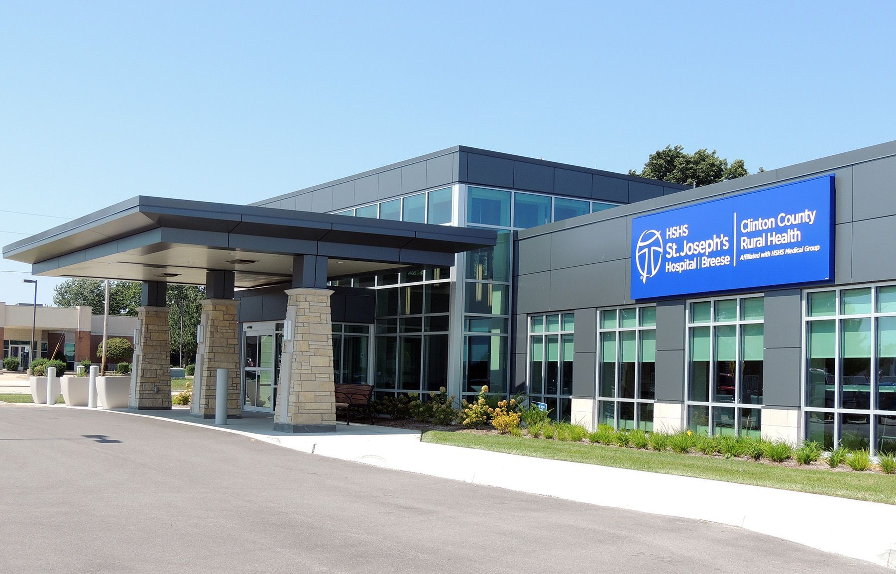 MRI machine covered in plastic in a medical room with tools, cabinets, and a window.
