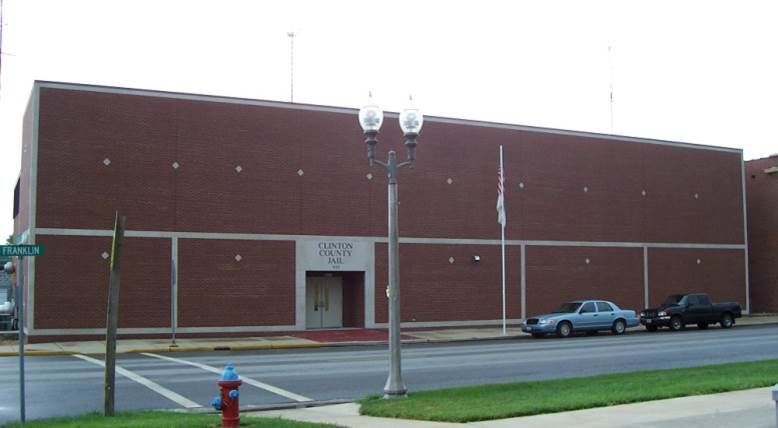 Brick building with large windows and a covered entrance; address 215 Park visible.