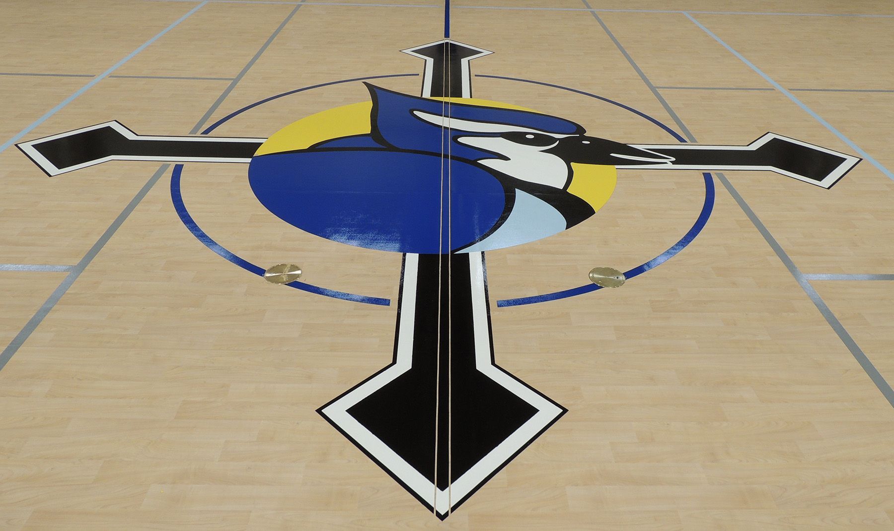 Blue lockers in a brightly lit locker room with benches; a red wall on the left.