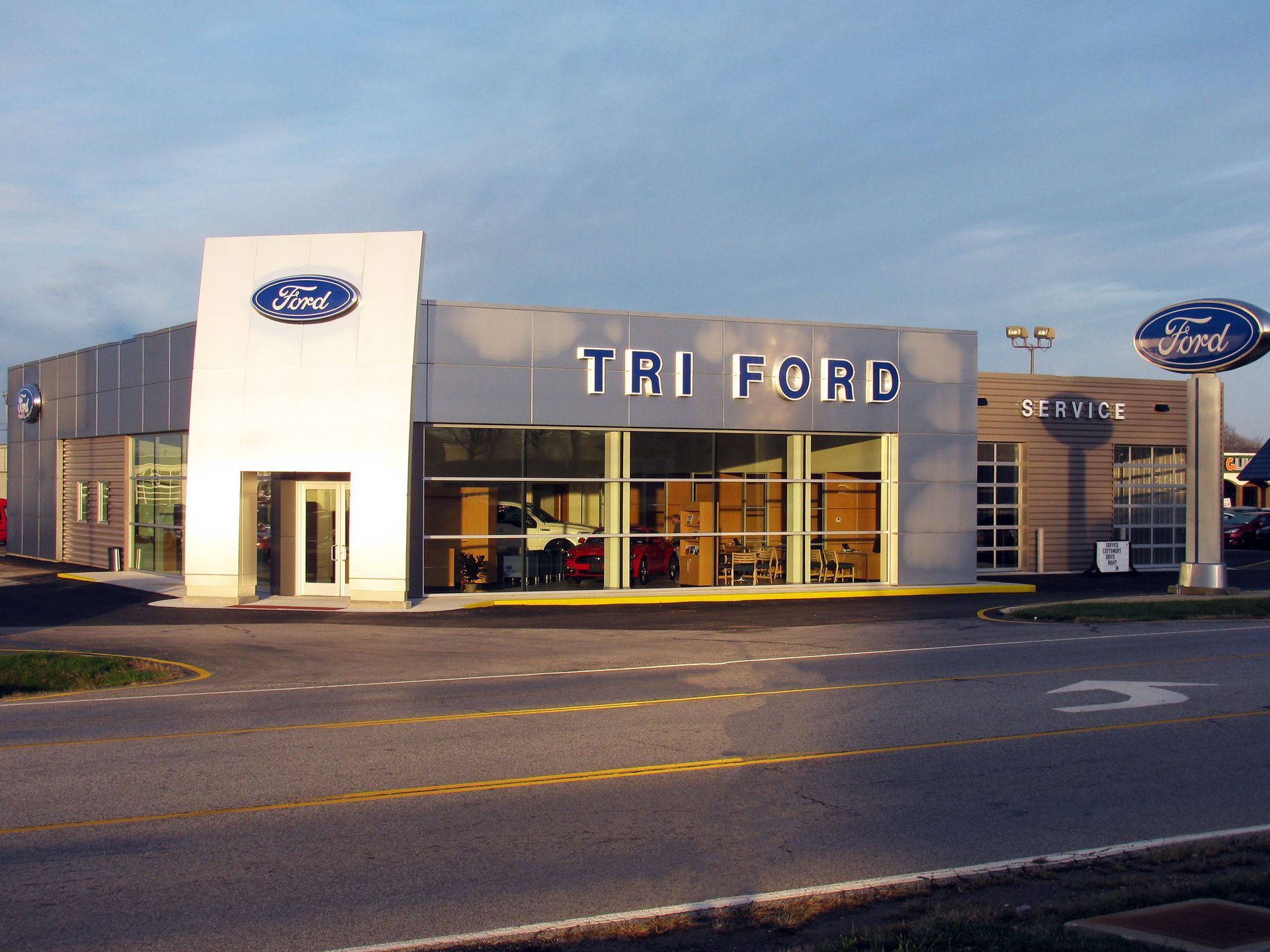 Tri Ford dealership building with sign; daytime.