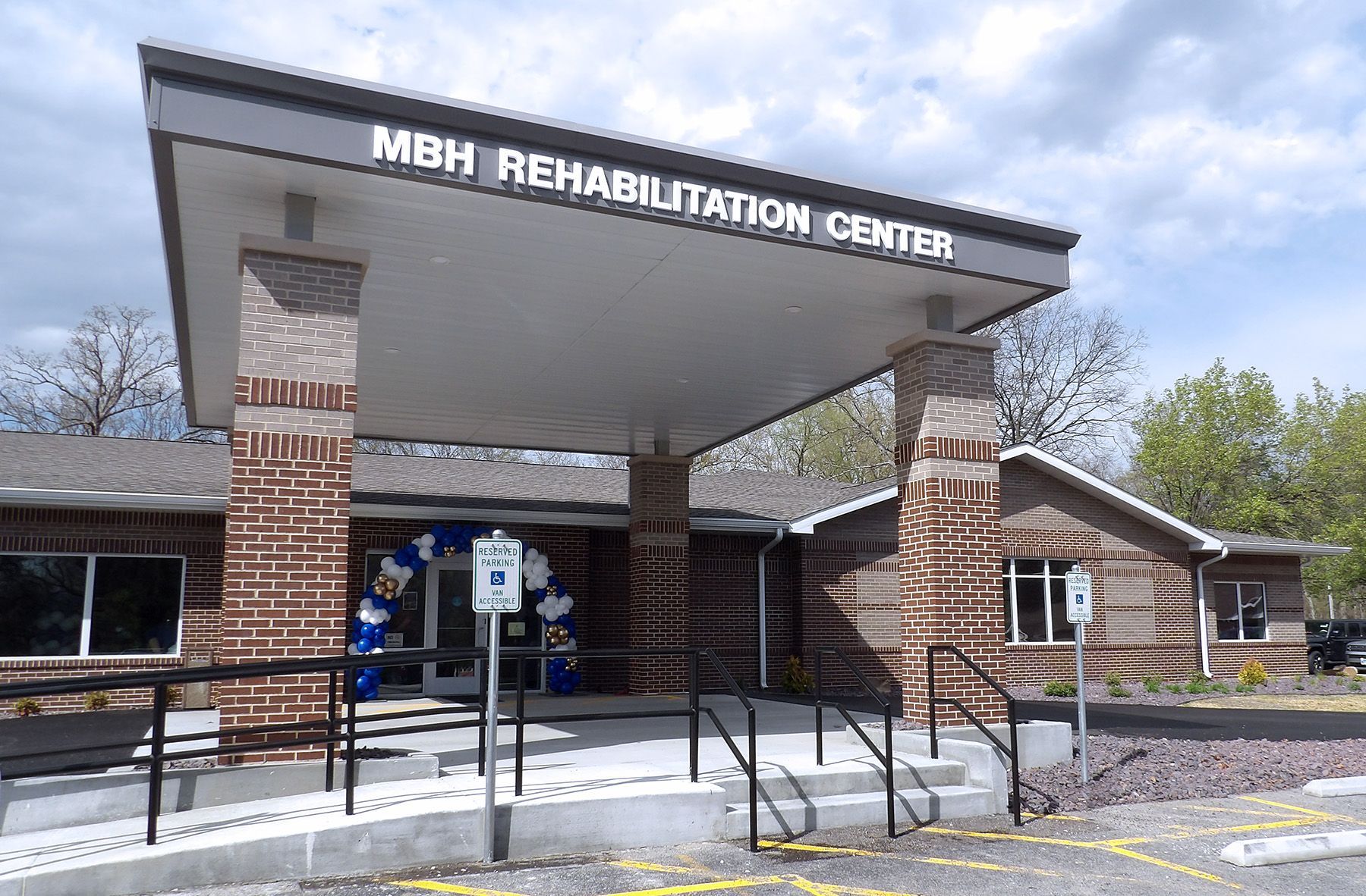Bar interior with stools, liquor bottles, and a lit sign.
