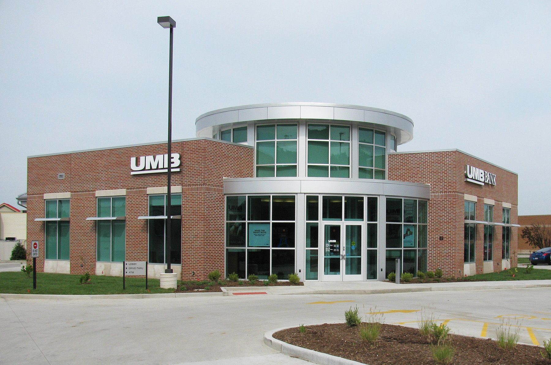 UMB Bank building with brick exterior and rounded glass entrance.