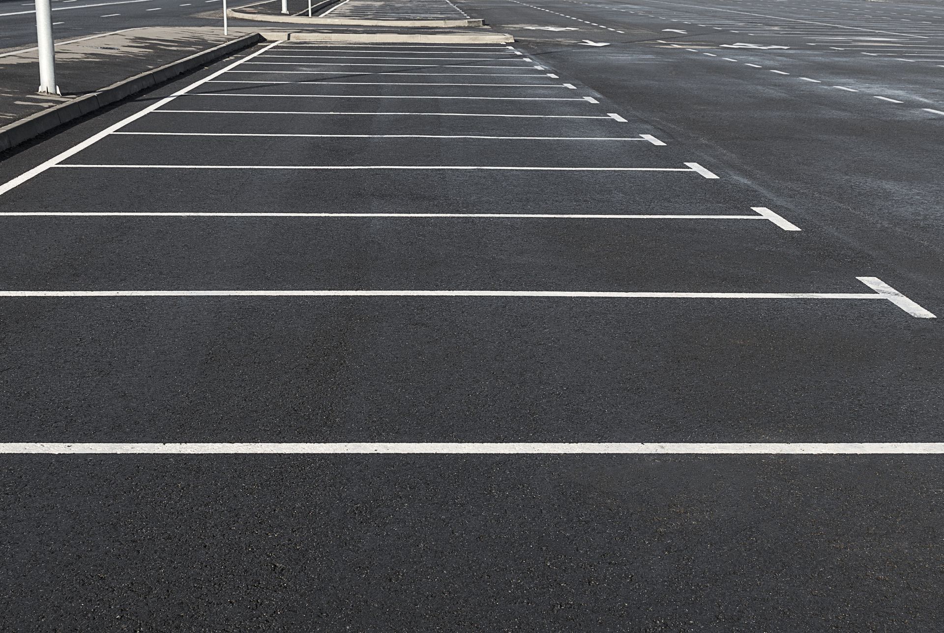 Empty parking lot with white space markings.