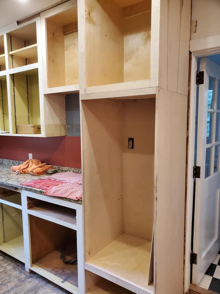 A kitchen with a lot of cabinets and a door.