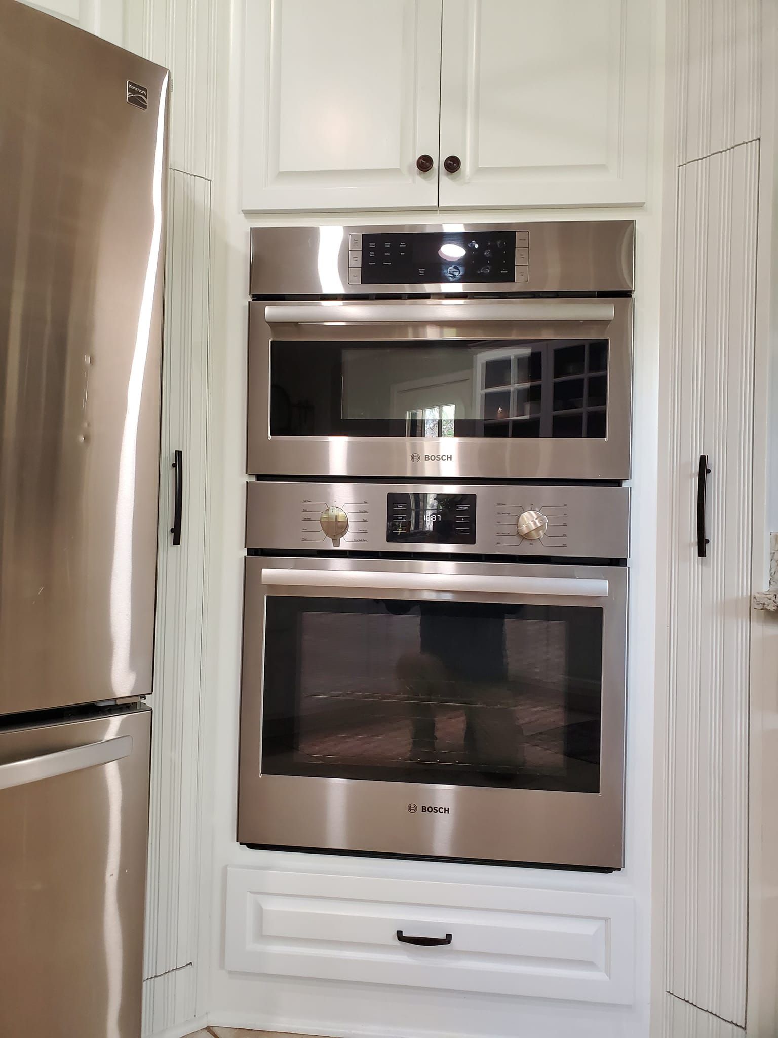 A kitchen with stainless steel appliances and a refrigerator