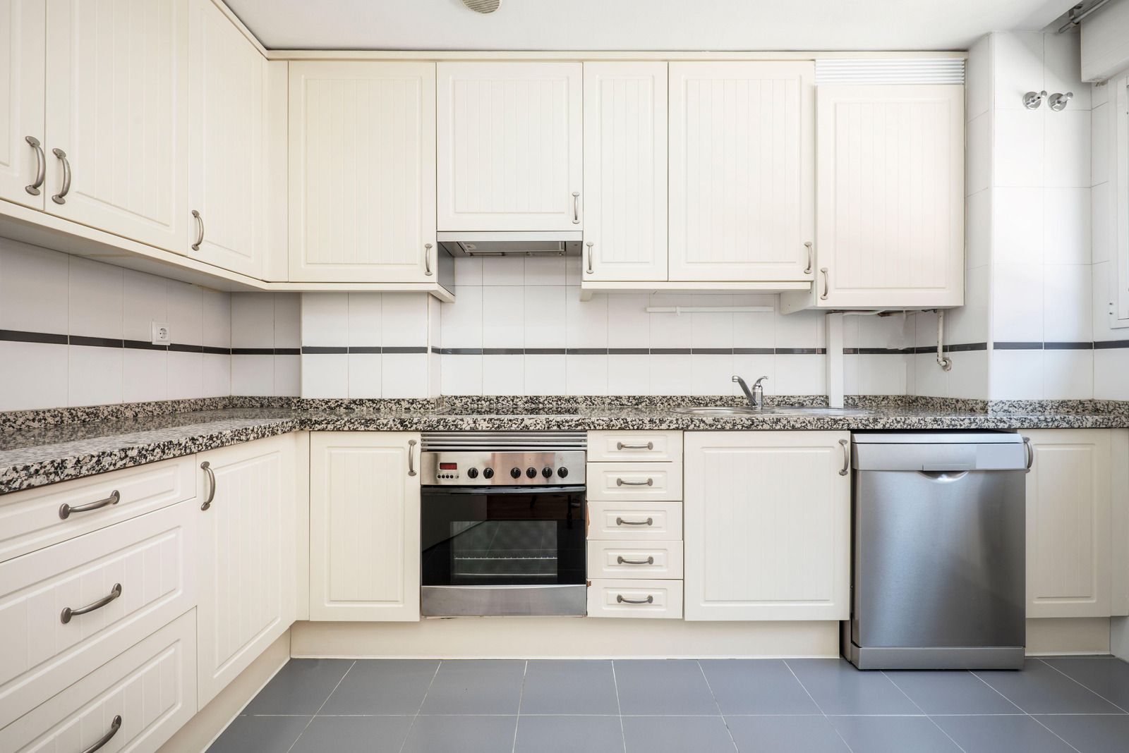 A kitchen with a large cabinet and a sink.