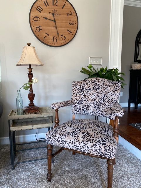 An end table, lamp, and chair with custom upholstery.