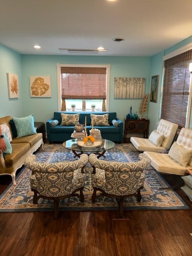 A living room with two couches and two chairs all with custom upholstery.