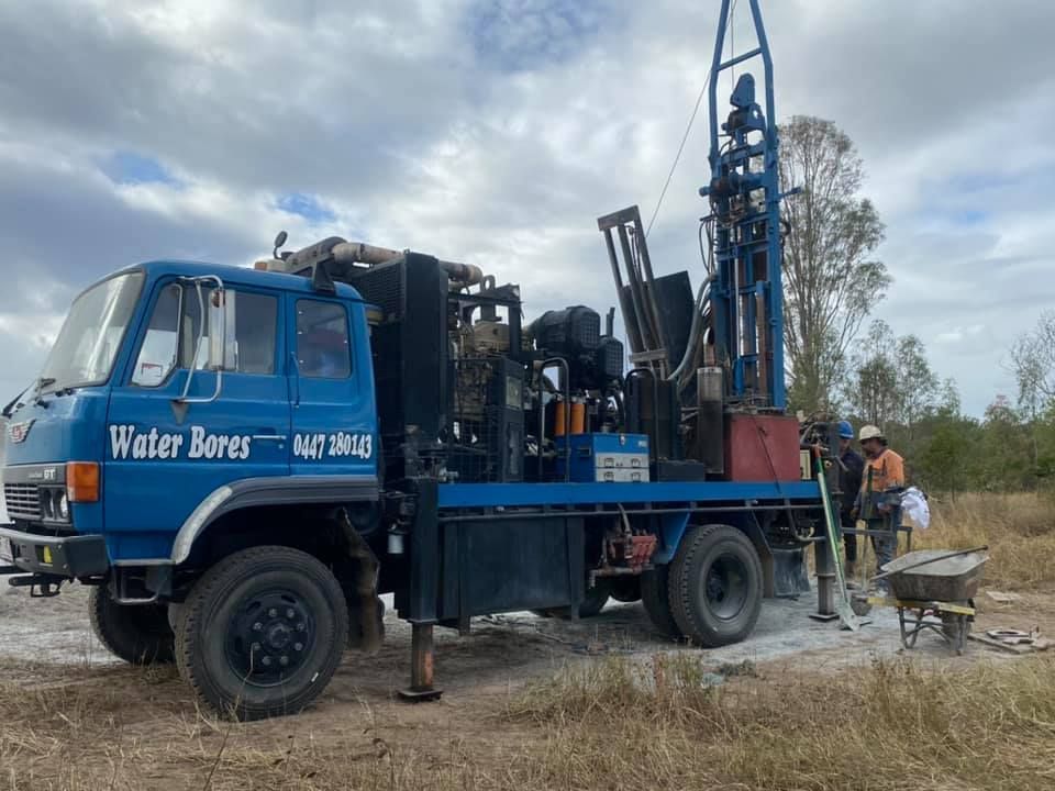 A Blue Truck is Parked in a Field With a Drilling Rig Attached to It — Cheyenne Drilling on the Sunshine Coast, QLD