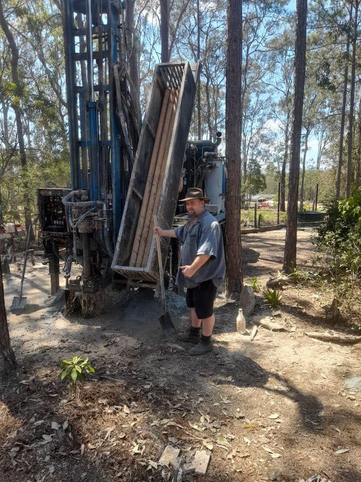 A Man is Standing in Front of a Machine in the Woods — Cheyenne Drilling on the Sunshine Coast, QLD