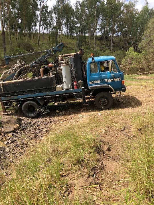 A Blue Truck is Parked in a Dirt Field — Cheyenne Drilling on the Sunshine Coast, QLD