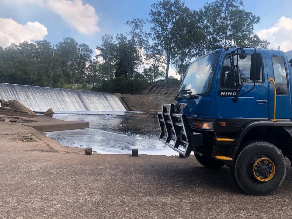 A Blue Truck is Parked in Front of a Waterfall — Cheyenne Drilling on the Sunshine Coast, QLD