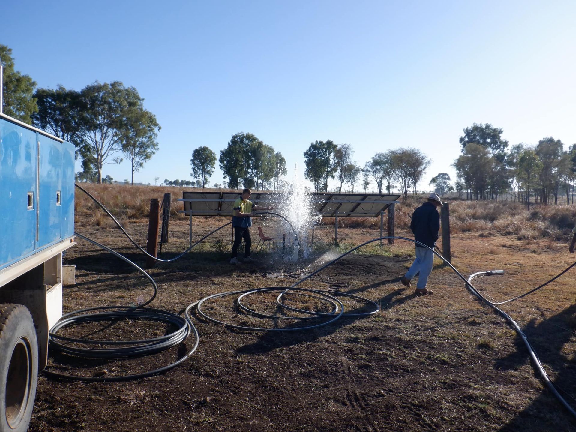 A Man is Spraying Water From a Hose in a Field — Cheyenne Drilling on the Sunshine Coast, QLD
