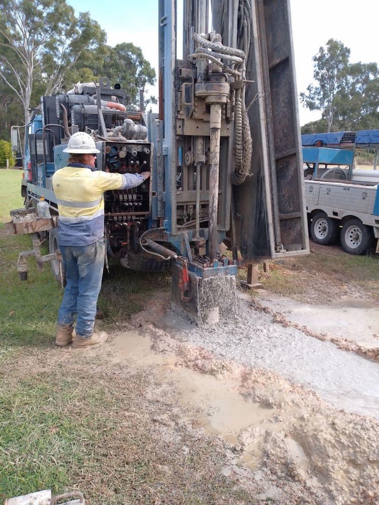 A Man is Standing in Front of a Large Machine — Cheyenne Drilling in Bundaberg, QLD