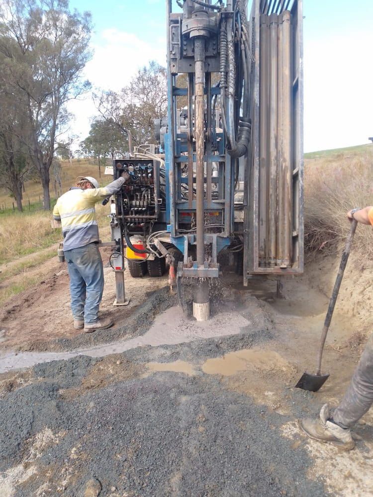 A Man is Standing Next to a Machine That is Drilling a Hole in the Ground — Cheyenne Drilling on the Sunshine Coast, QLD