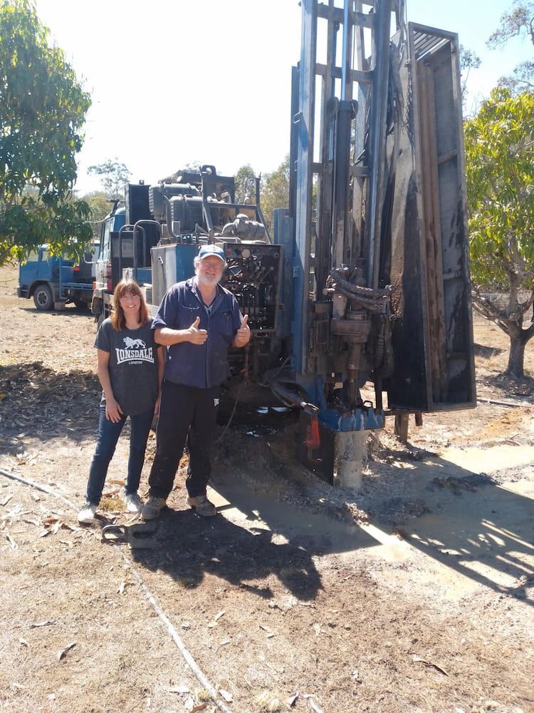 A Man and a Woman Are Standing in Front of a Large Machine — Cheyenne Drilling on the Sunshine Coast, QLD