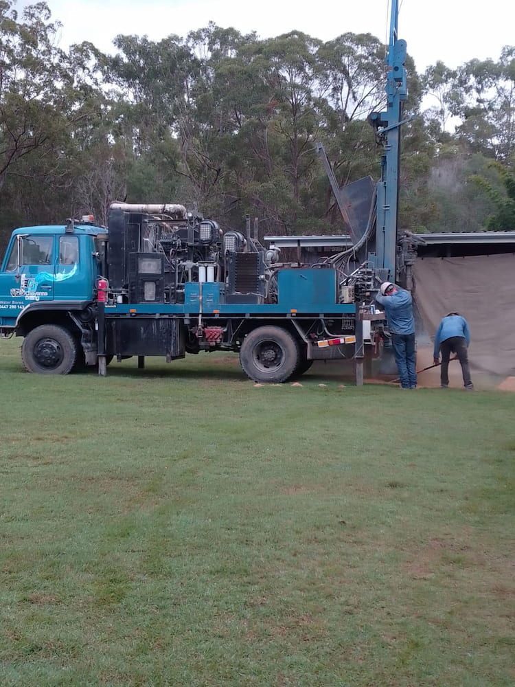 A Blue Truck is Parked in a Grassy Field — Cheyenne Drilling on the Sunshine Coast, QLD