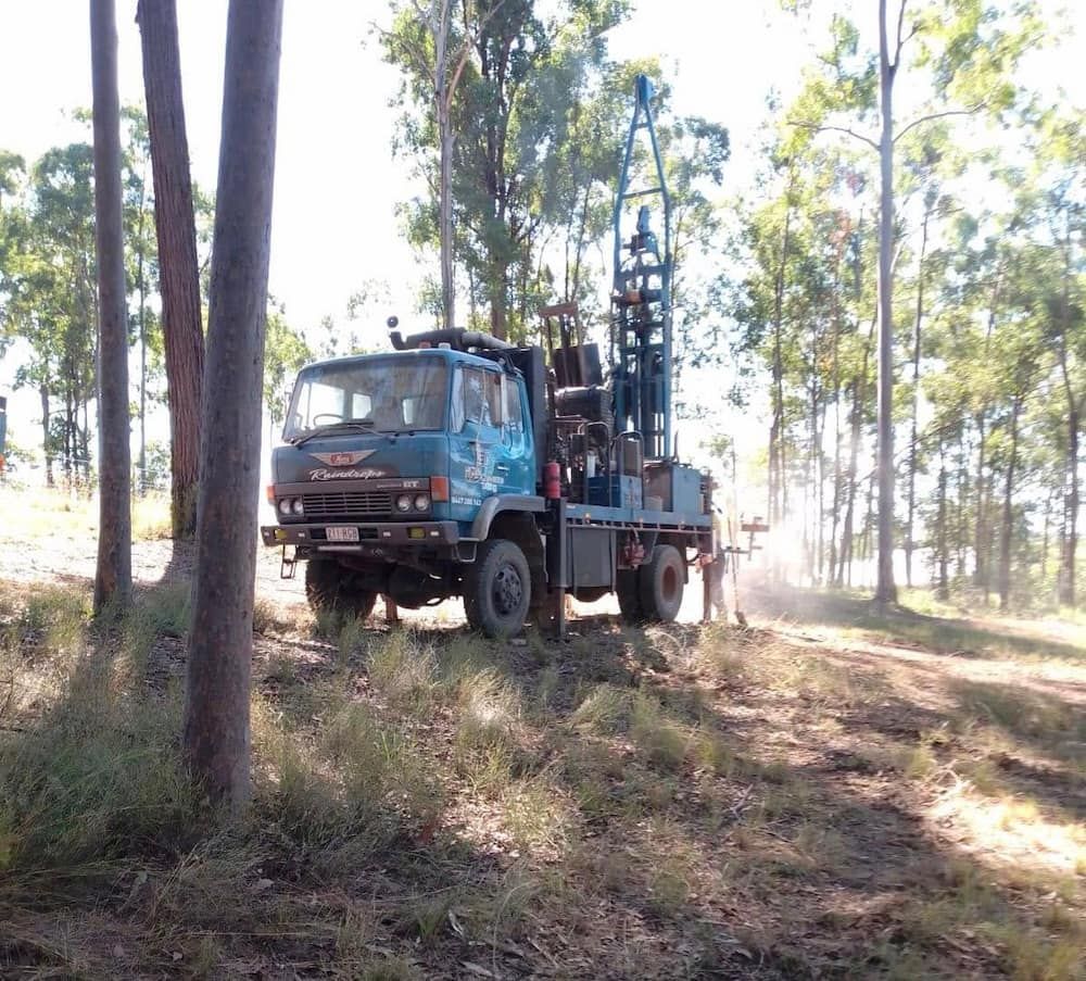 A Blue Truck is Parked in the Middle of a Forest — Cheyenne Drilling on the Sunshine Coast, QLD