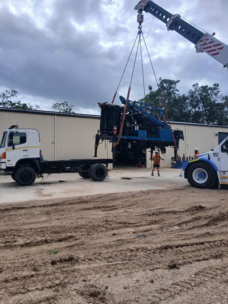 A Truck is Lifting a Drilling Machine — Cheyenne Drilling in Bundaberg, QLD