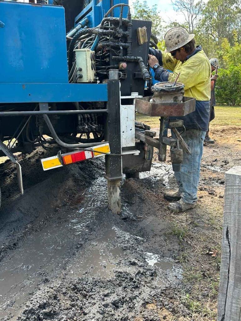 A Man is Working on a Machine in the Mud — Cheyenne Drilling on the Sunshine Coast, QLD