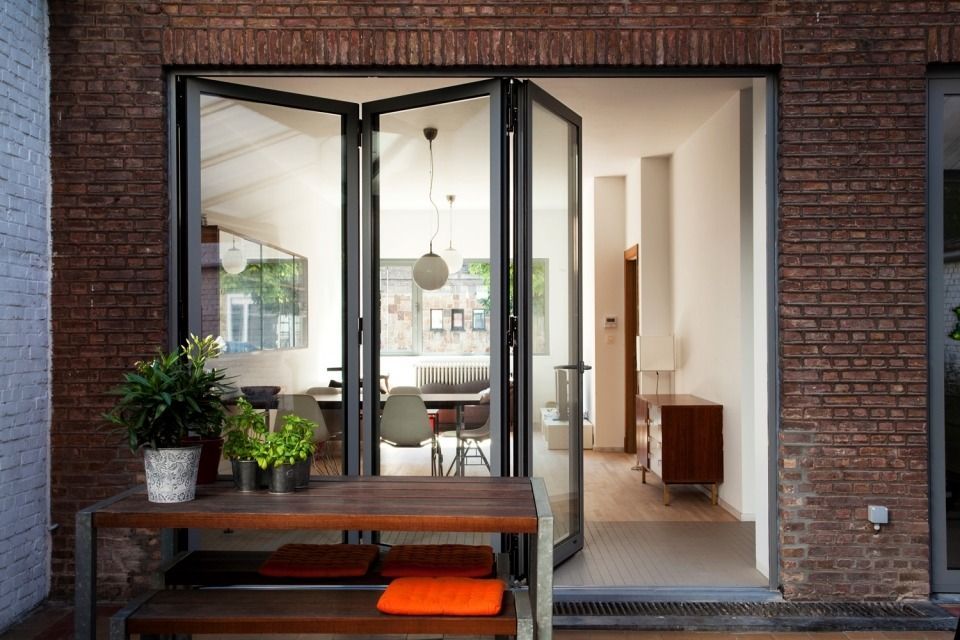 A brick building with a table and bench in front of it