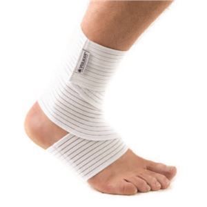 A person wearing a white bandage on their ankle