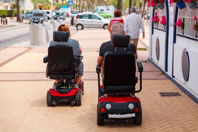 Couple Elderly People Ride Along the Sidewalk — Healthcare Equipment in Wyong