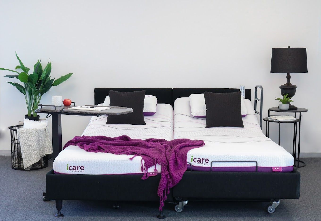 A bed with a purple blanket on it that says icare