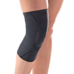 A person is wearing a black knee brace on their leg.