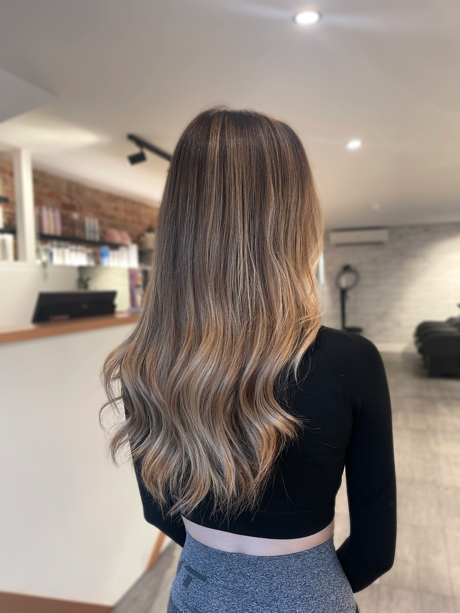 A woman with long hair is standing in a room at Samson &Delilah.