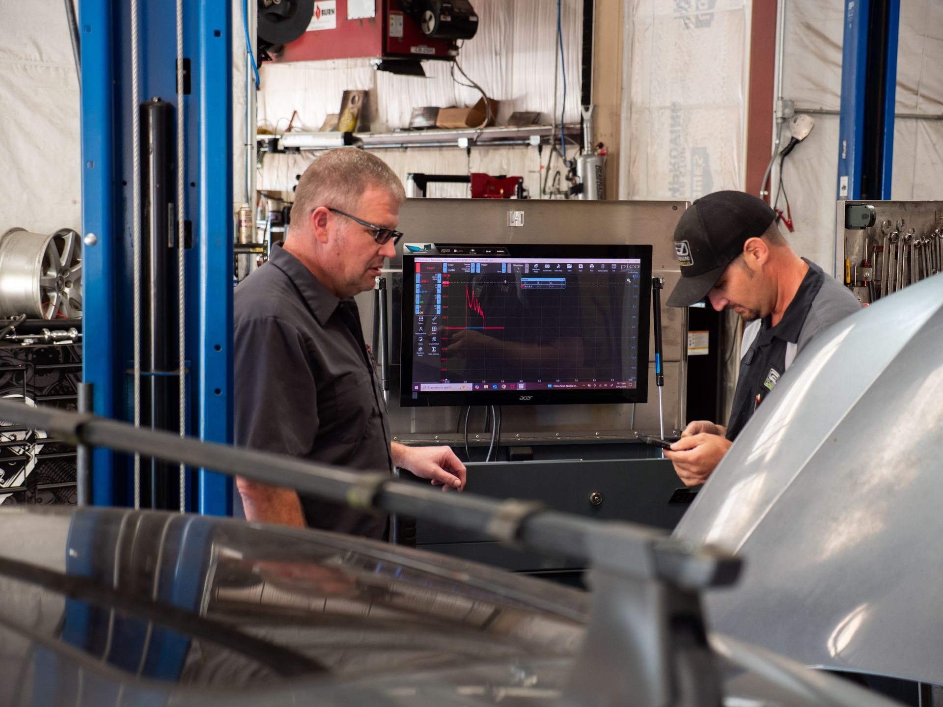 Mid-century modern credenza with a lamp and decorative objects, in a sunlit room.