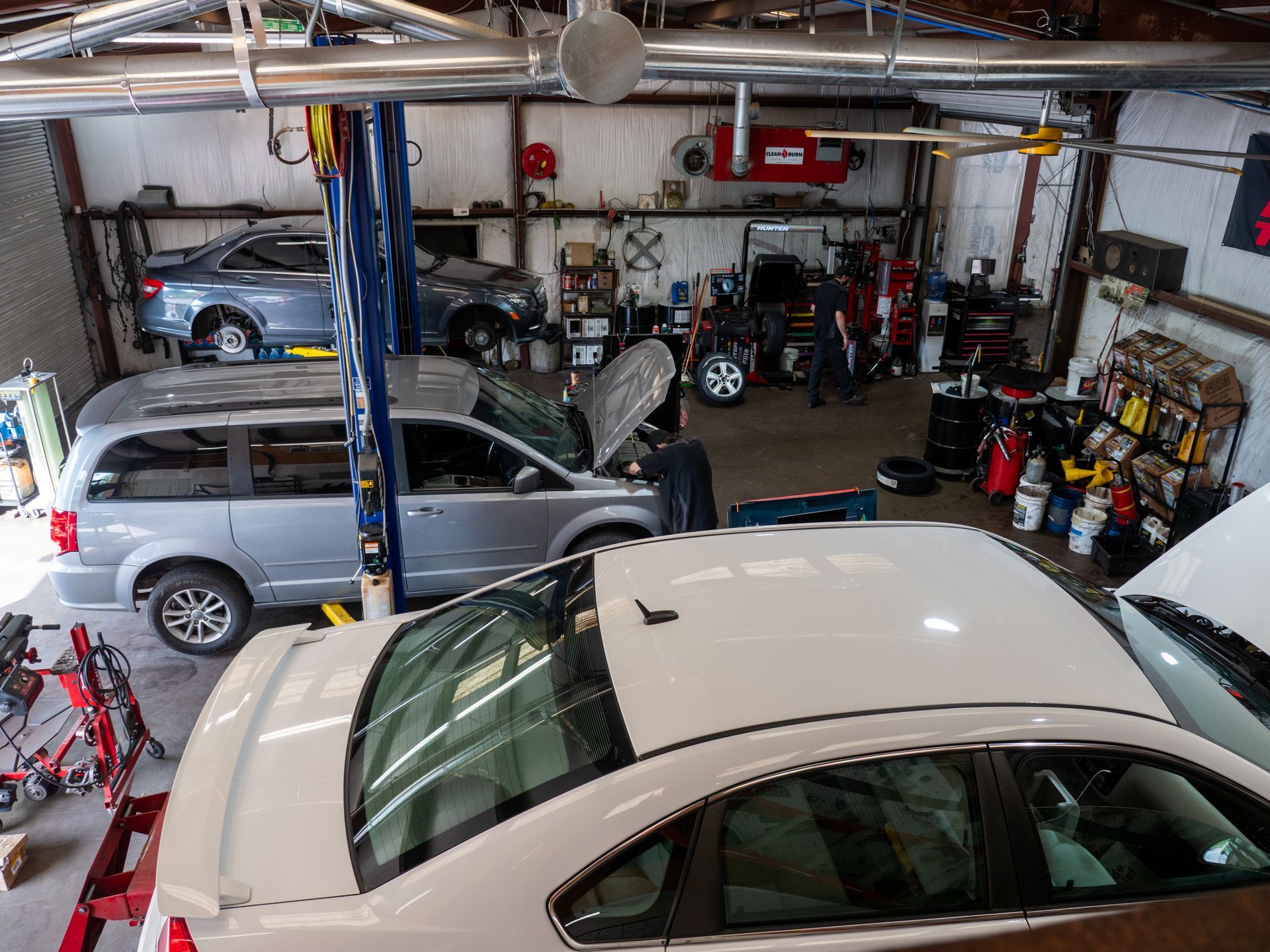 Mid-century modern credenza with a lamp and decorative objects, in a sunlit room.