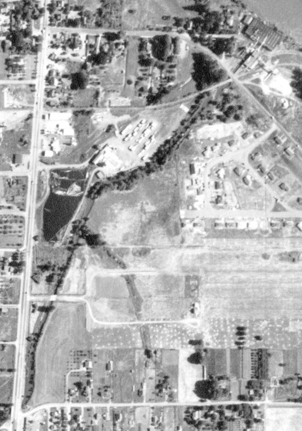 The Log Pond for the Dog Face Lumber Company (Lester Harvey, owner) first appears in this 1948 aerial photo.