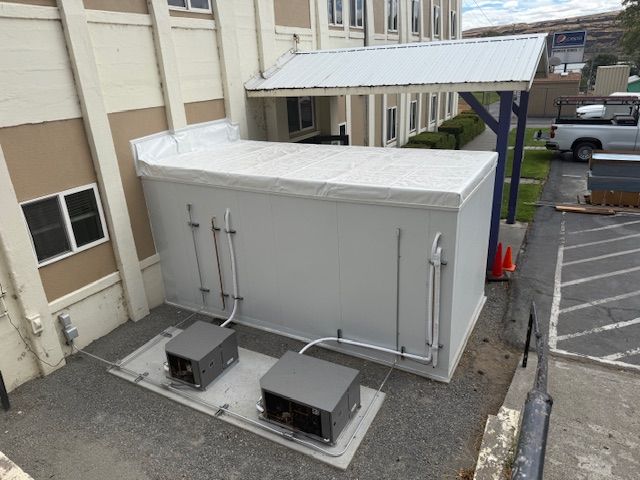 Long row of refrigerated glass-door display cases in a supermarket aisle, filled with various packaged food items.